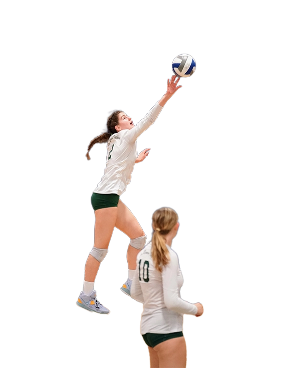 A girl jumps to hit the ball during a volleyball game.